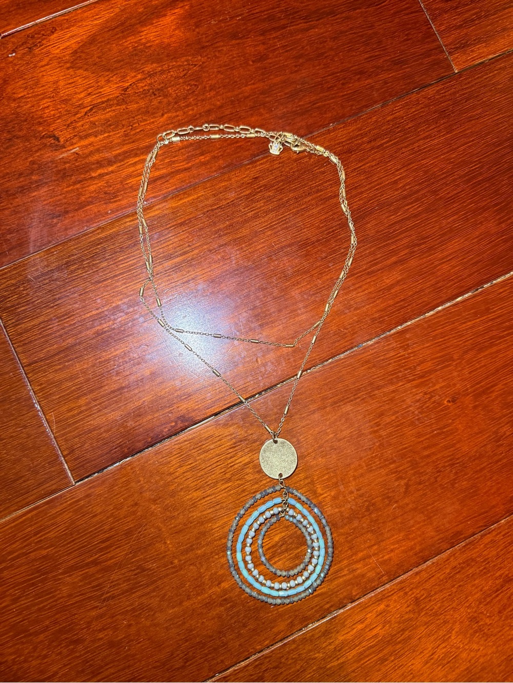 Gold Layered Necklace with Light Blue Beaded Hoop Pendant